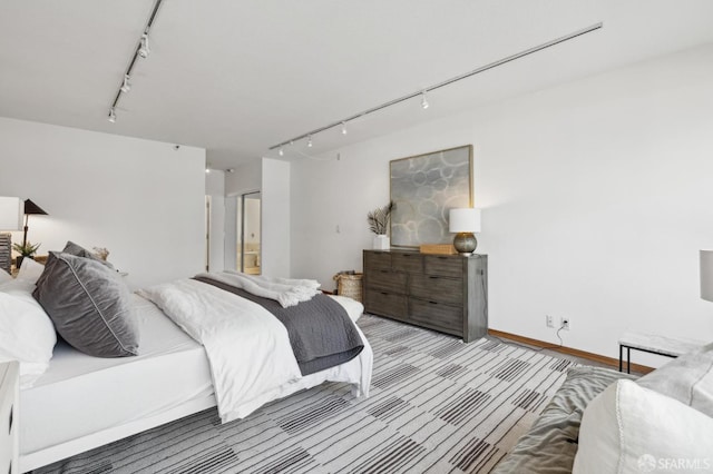 bedroom featuring rail lighting