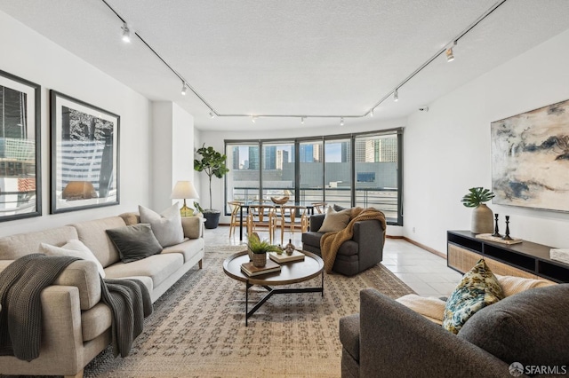 living room featuring light tile patterned flooring and a textured ceiling