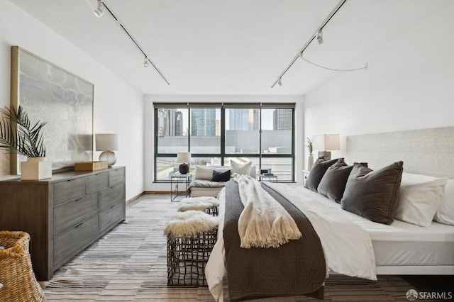 bedroom featuring track lighting