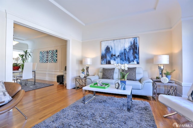 living room featuring hardwood / wood-style flooring and crown molding