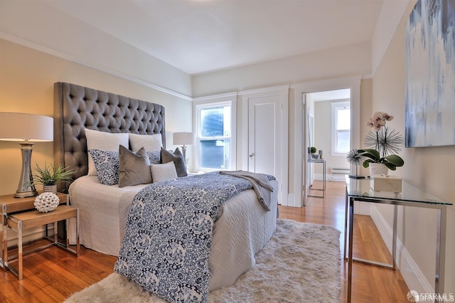 bedroom featuring a baseboard radiator and hardwood / wood-style floors