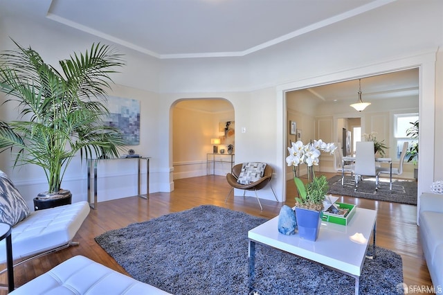 living room with crown molding and hardwood / wood-style floors