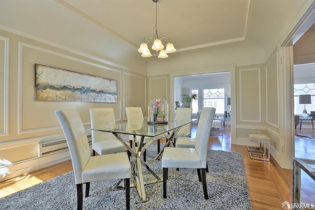 dining room featuring baseboard heating and a notable chandelier