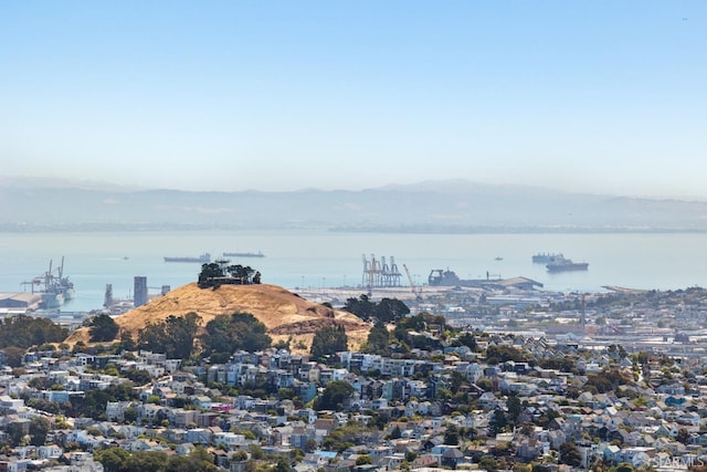 exterior space with a water and mountain view