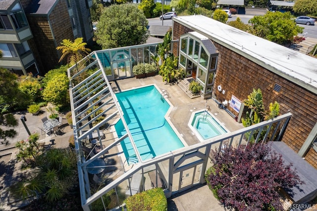 view of pool with a hot tub and a patio area