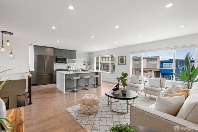 living area featuring recessed lighting and light wood-style flooring