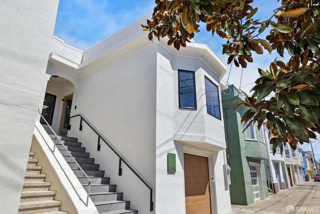 738 Athens St, San Francisco, CA 94112 - view of side of property with stairway and stucco siding