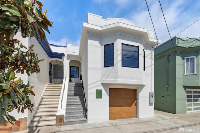 738 Athens St, San Francisco, CA 94112 - view of front of home with stucco siding, an attached garage, and driveway