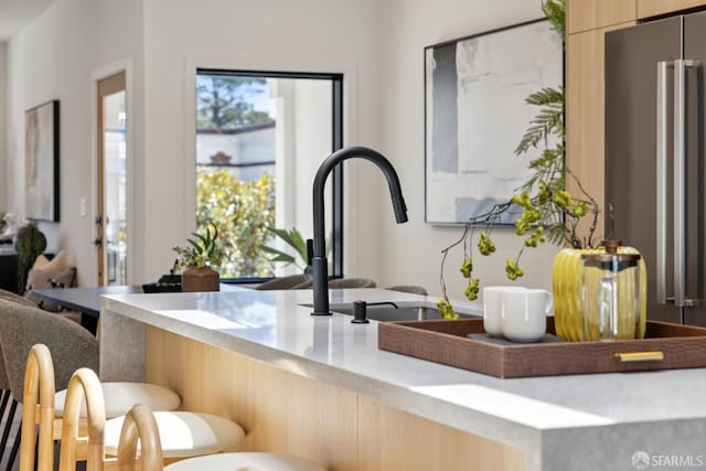 738 Athens St, San Francisco, CA 94112 - kitchen with a kitchen breakfast bar, modern cabinets, light countertops, and light brown cabinetry