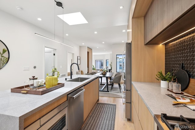 738 Athens St, San Francisco, CA 94112 - kitchen with modern cabinets, stainless steel dishwasher, light wood finished floors, recessed lighting, and light countertops
