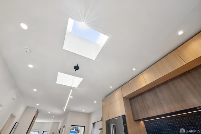 738 Athens St, San Francisco, CA 94112 - detailed view of a skylight, light brown cabinets, modern cabinets, freestanding refrigerator, and recessed lighting