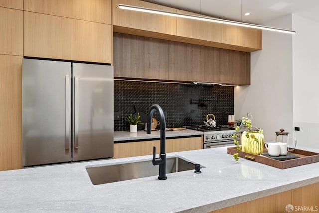 738 Athens St, San Francisco, CA 94112 - kitchen featuring appliances with stainless steel finishes, backsplash, modern cabinets, and light stone countertops
