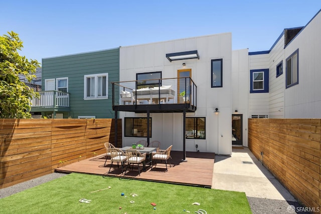 738 Athens St, San Francisco, CA 94112 - rear view of property with board and batten siding, a balcony, a fenced backyard, outdoor dining area, and a wooden deck