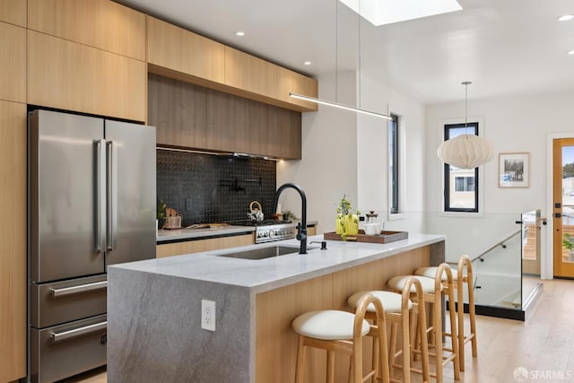738 Athens St, San Francisco, CA 94112 - kitchen featuring high quality fridge, modern cabinets, tasteful backsplash, light stone countertops, and light wood-type flooring