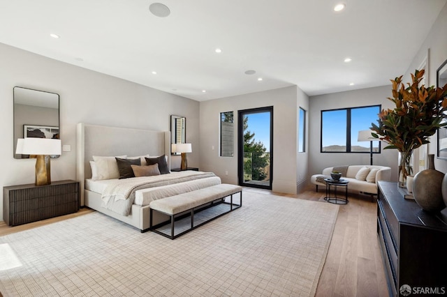 bedroom with access to outside and light hardwood / wood-style floors