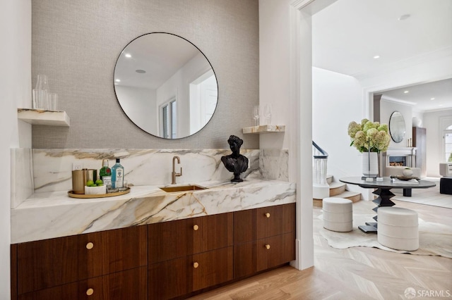 bathroom with crown molding, parquet flooring, and vanity