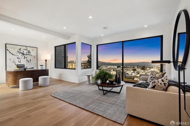 living room featuring beam ceiling and hardwood / wood-style floors