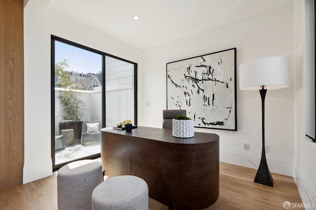 office area with light hardwood / wood-style floors