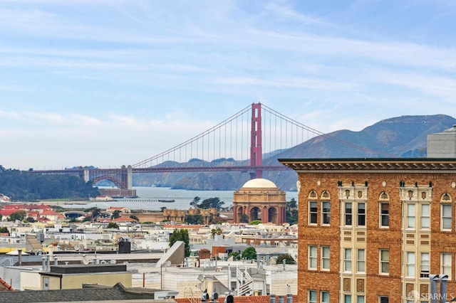 property's view of city with a water and mountain view