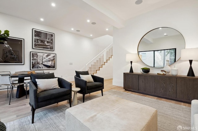 living room featuring light hardwood / wood-style flooring and beamed ceiling