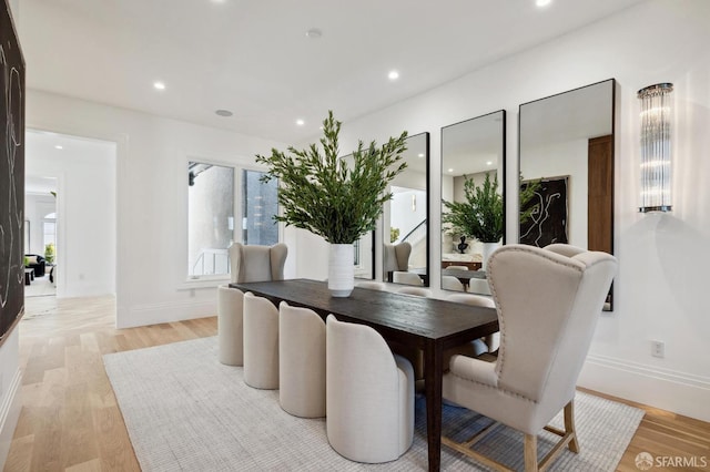 dining space with light hardwood / wood-style flooring