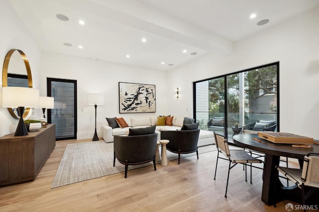 living room featuring light hardwood / wood-style flooring and beamed ceiling