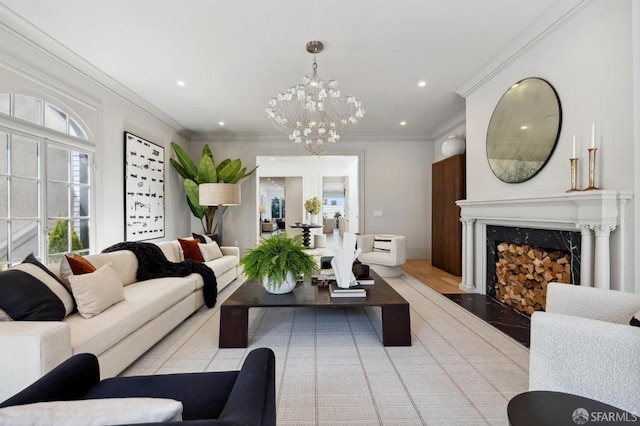 living room featuring a notable chandelier, ornamental molding, a premium fireplace, and light wood-type flooring