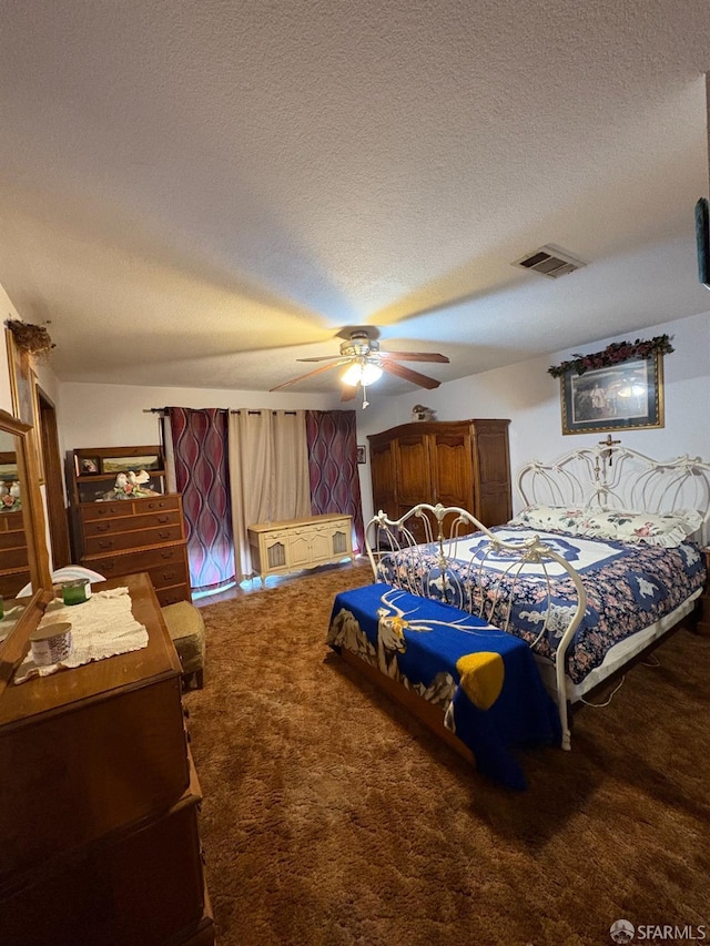 carpeted bedroom with a textured ceiling and ceiling fan