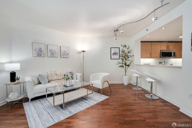 living area with recessed lighting, baseboards, and wood finished floors