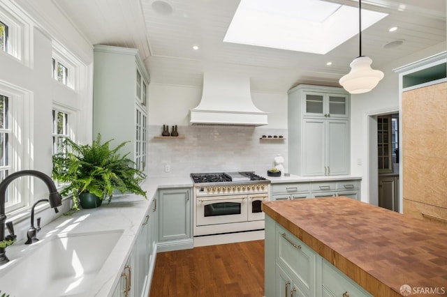 318 Caselli Ave, San Francisco, CA 94114 - kitchen featuring double oven range, butcher block countertops, a sink, premium range hood, and a skylight