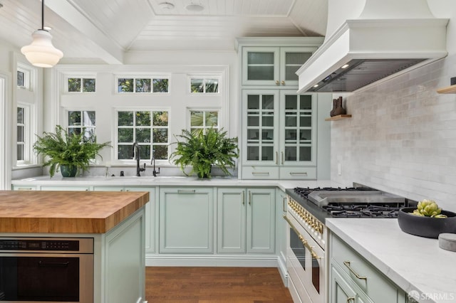 318 Caselli Ave, San Francisco, CA 94114 - kitchen with custom exhaust hood, wooden counters, gas range oven, decorative backsplash, and stainless steel oven