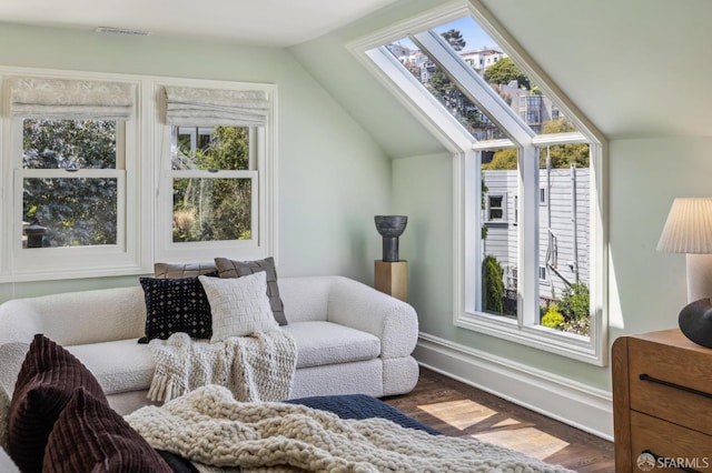 318 Caselli Ave, San Francisco, CA 94114 - living area featuring a skylight, wood finished floors, vaulted ceiling, plenty of natural light, and baseboards