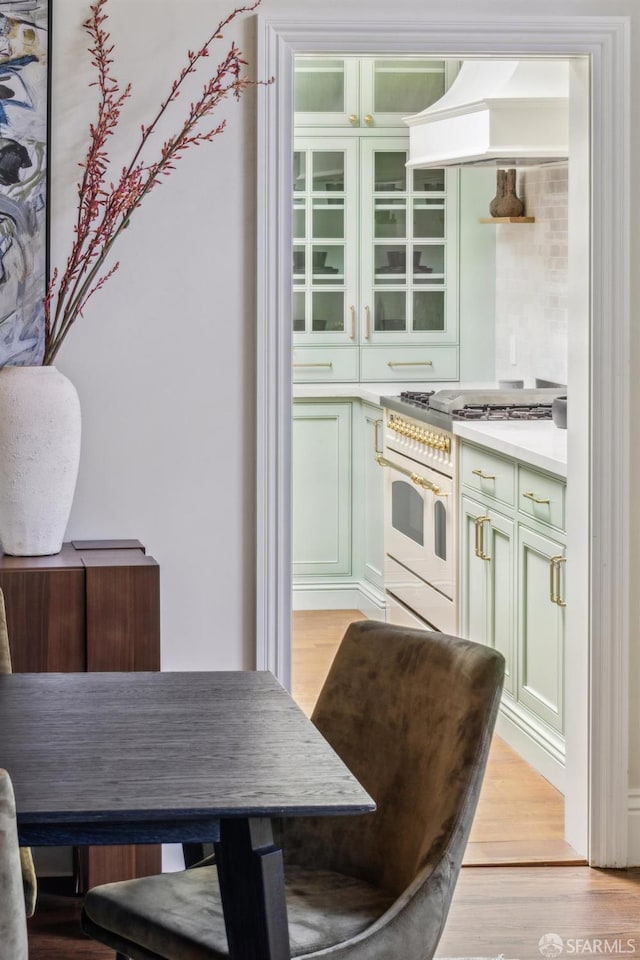 318 Caselli Ave, San Francisco, CA 94114 - kitchen featuring stainless steel range, light wood-type flooring, light countertops, and custom exhaust hood