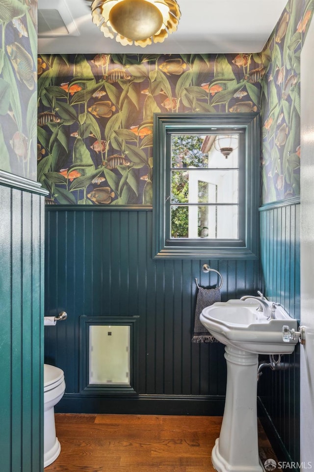 318 Caselli Ave, San Francisco, CA 94114 - bathroom with wallpapered walls, wood finished floors, and toilet