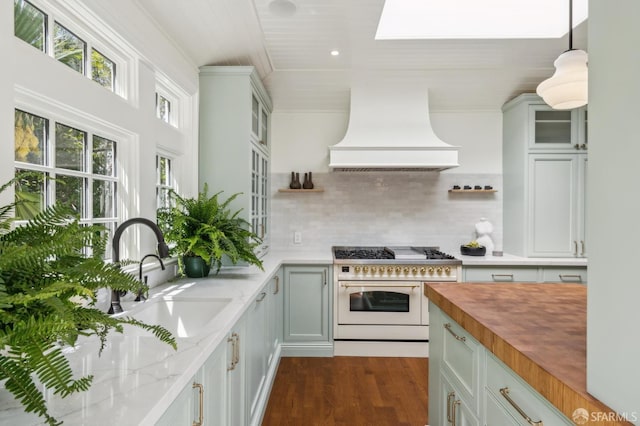 318 Caselli Ave, San Francisco, CA 94114 - kitchen featuring range with two ovens, premium range hood, wood counters, a sink, and backsplash
