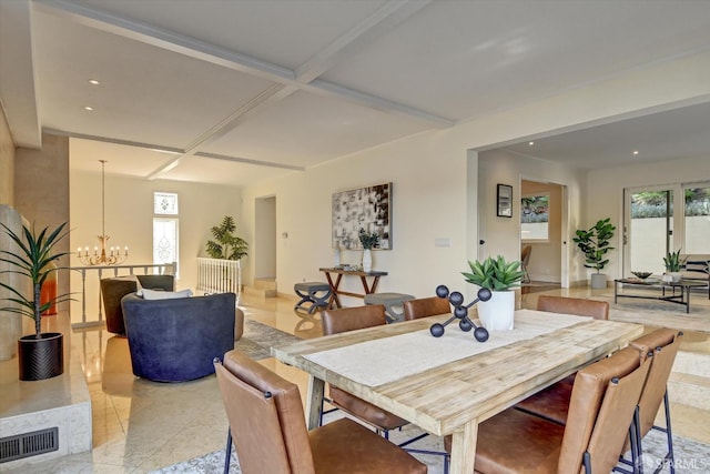 dining room featuring coffered ceiling and a notable chandelier