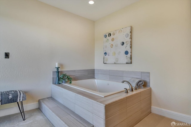 bathroom with a relaxing tiled tub