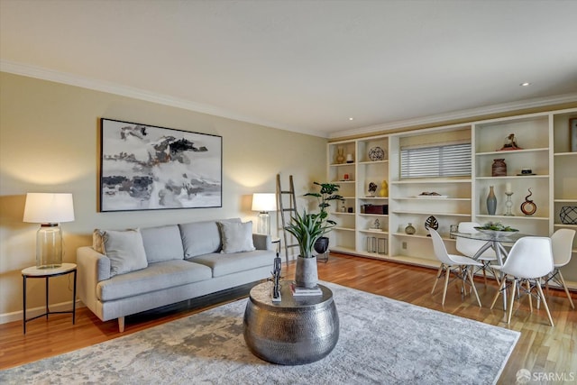 living room with hardwood / wood-style floors and crown molding