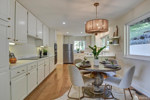 dining space with light hardwood / wood-style flooring