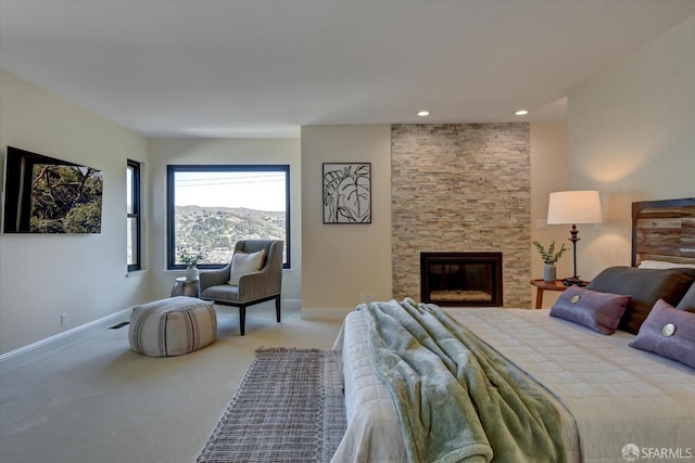 bedroom with a mountain view, carpet flooring, and a fireplace