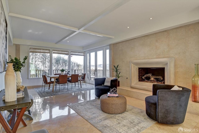 living room featuring coffered ceiling, beamed ceiling, and a healthy amount of sunlight