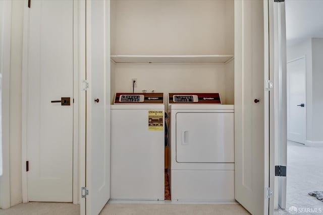 clothes washing area featuring washer and dryer