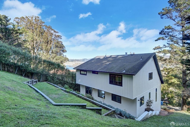 view of side of property with a lawn