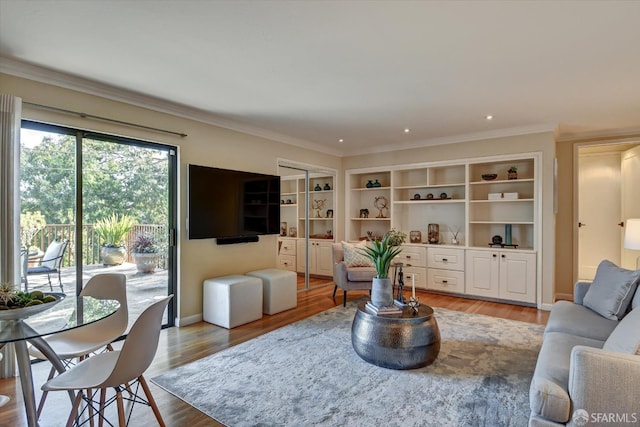 living room with ornamental molding and light hardwood / wood-style floors