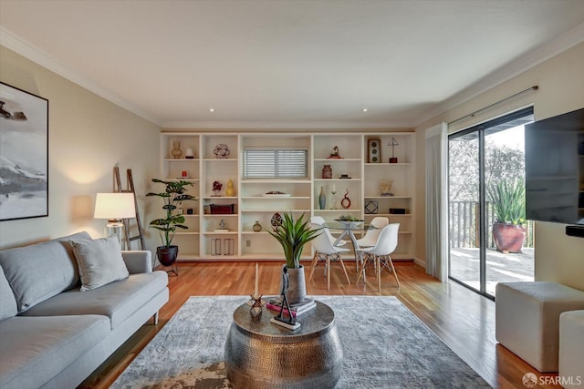 living room with hardwood / wood-style flooring and crown molding