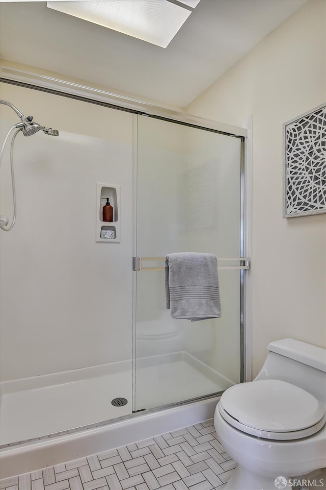 bathroom featuring toilet and walk in shower