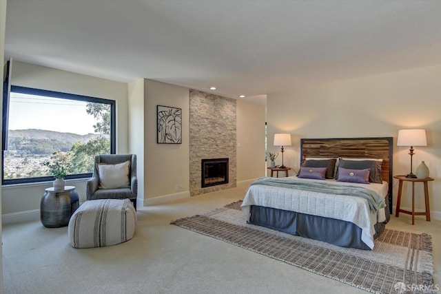 carpeted bedroom featuring a mountain view and a fireplace