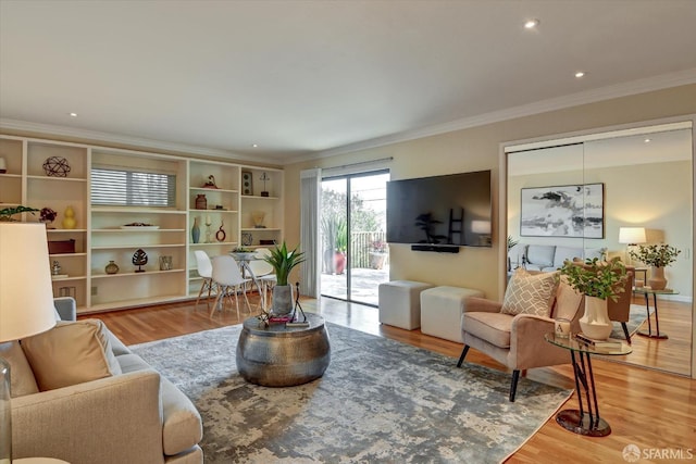 living room featuring hardwood / wood-style floors and crown molding