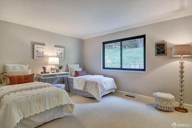 bedroom with crown molding and carpet floors