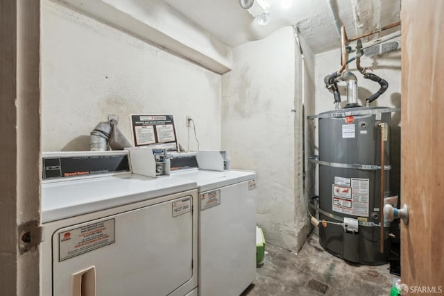 utility room with water heater and washing machine and clothes dryer